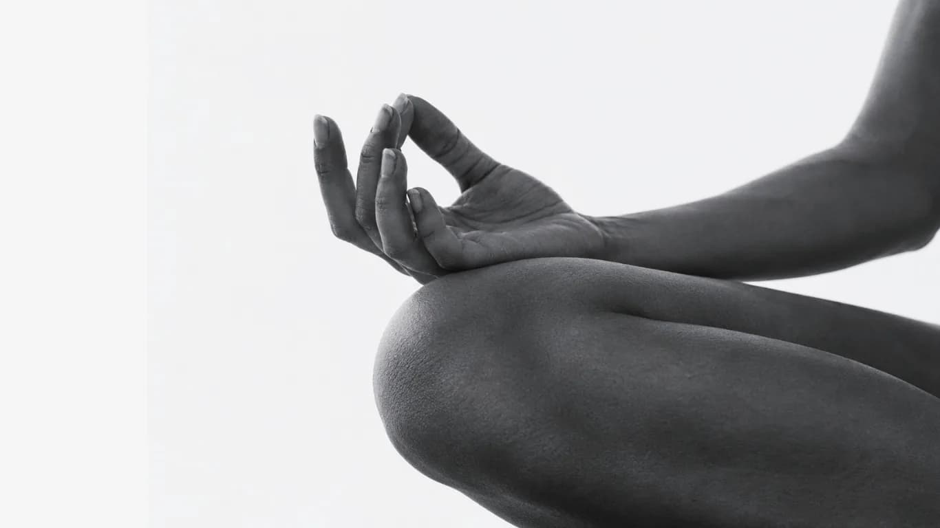 Hands resting in a meditation pose, black and white